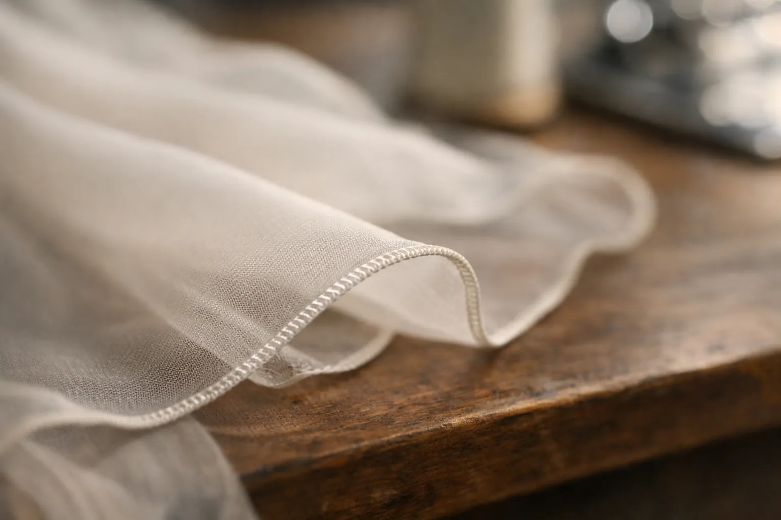 A narrow rolled hem serged on the edge of sheer fabric